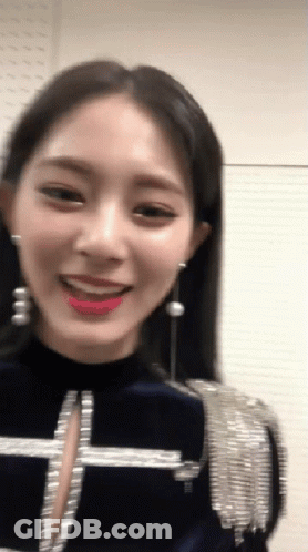 Woman With Earrings In Blue Top GIF