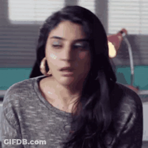 Woman With Eyes Closed And Gray Shirt GIF