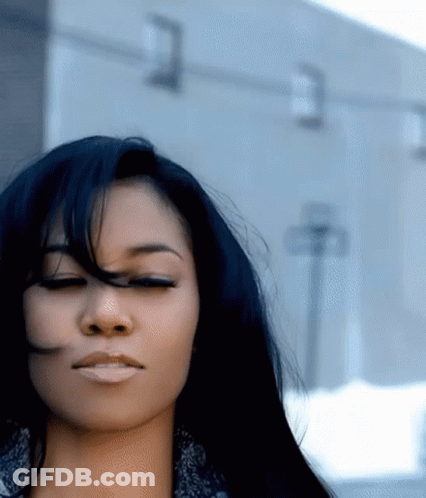 Woman With Eyes Closed And Hair Blowing In Wind GIF