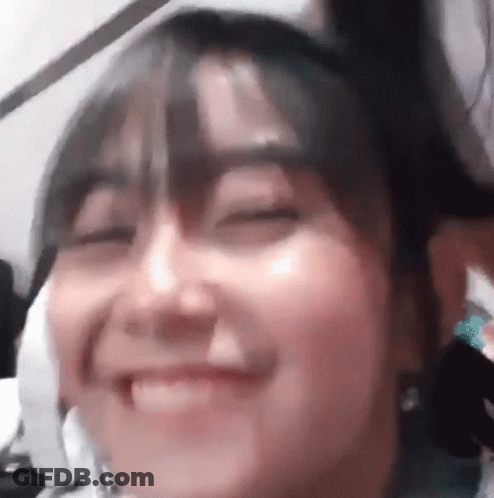 Woman With Eyes Closed And Hair In Bun GIF