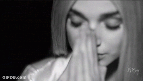 Woman With Eyes Closed And Hands On Face GIF