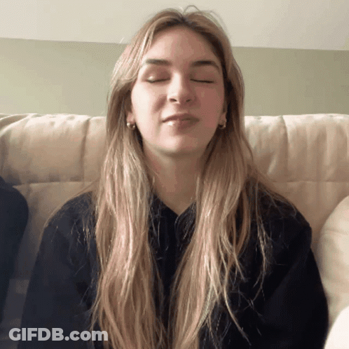 Woman With Eyes Closed In Black Sweater GIF
