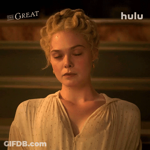 Woman With Eyes Closed In Front Of Hulu Logo GIF
