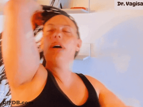 Woman With Eyes Closed In Front Of Sign That Says Dr. Vagisa GIF