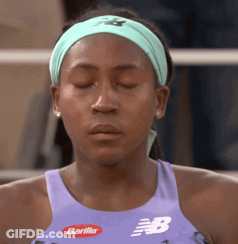 Woman With Eyes Closed In Purple Tank Top With Letter B GIF