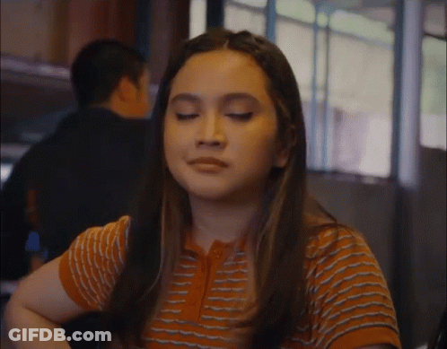 Woman With Eyes Closed In Striped Shirt GIF