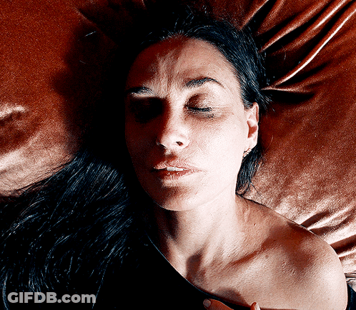 Woman With Eyes Closed Laying On Bed GIF