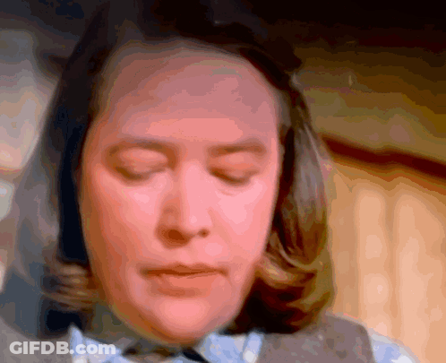 Woman With Eyes Closed Looking At Camera GIF