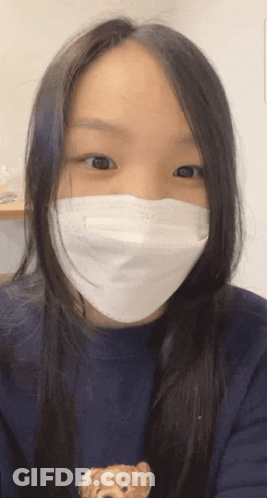 Woman With Face Mask And Teddy Bear Sweater GIF