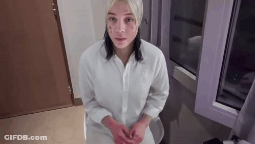 Woman With Face Tattoo Sitting On Toilet GIF
