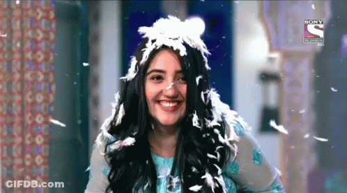 Woman With Feather Headpiece Smiling GIF