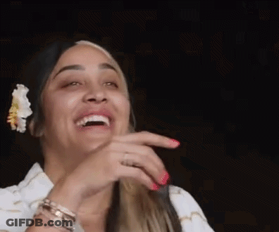 Woman With Flower In Hair Laughing Hand To Face GIF