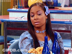 Woman With Flower In Hair Sitting At Table GIF