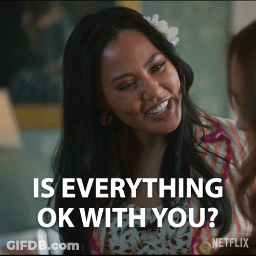 Woman With Flower In Hair Smiling Asking Everything Ok GIF