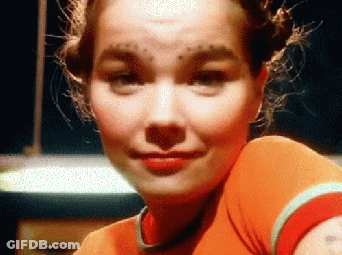 Woman With Forehead Tattoo And Red Shirt GIF
