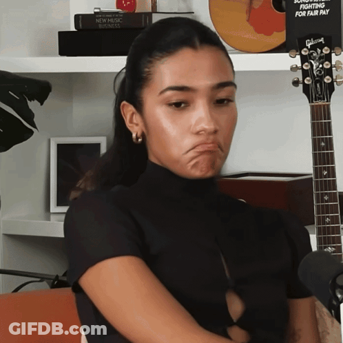 Woman With Gibson Guitar Making Face GIF