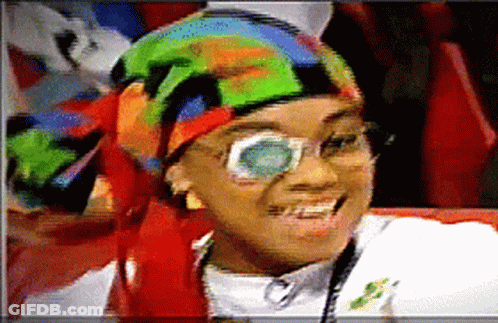 Woman With Glasses And Colorful Head Scarf Smiling GIF