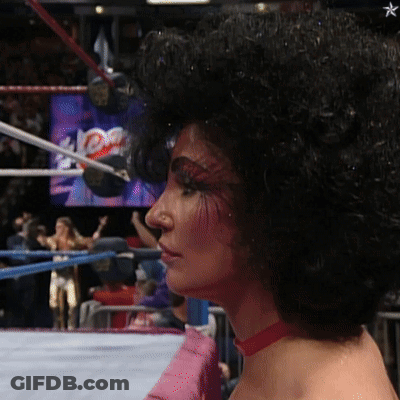 Woman With Glasses And Feathered Sleeves Saying Phe- GIF