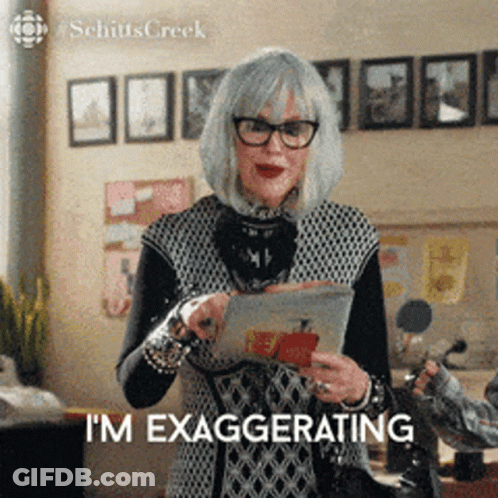 Woman With Glasses And Gray Hair Holding Tablet Saying I'm Exaggerating GIF