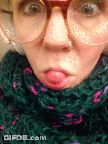 Woman With Glasses And Green Scarf Making Funny Face GIF