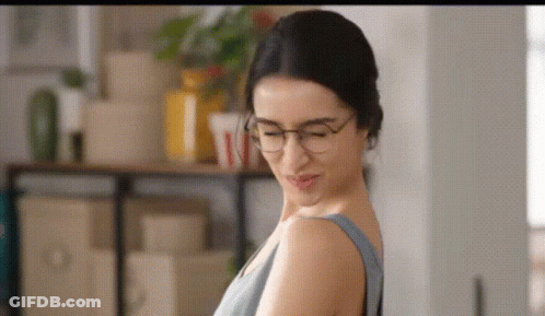 Woman With Glasses And Grey Tank Top GIF