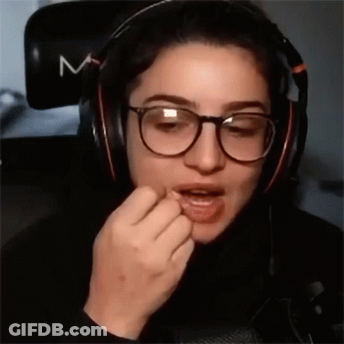 Woman With Glasses And Headphones Eating GIF