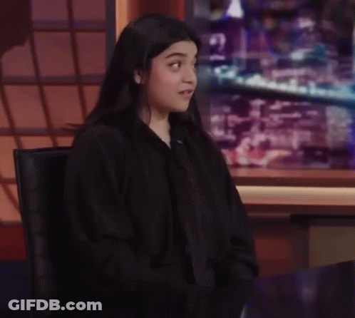 Woman With Glasses And Headphones Making Funny Face Saying Little Ups And Downs GIF