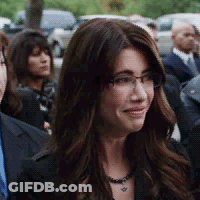Woman With Glasses And Necklace In Crowd GIF