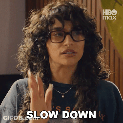 Woman With Glasses And Necklace Saying Slow Down GIF