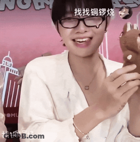 Woman With Glasses And Necklace Smiling Beside Now Sign GIF