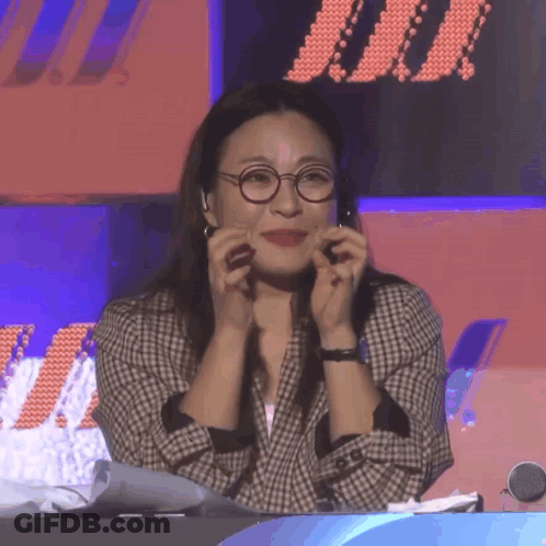 Woman With Glasses And Plaid Jacket Hands On Face GIF