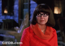 Woman With Glasses And Red Scarf Making A Face GIF