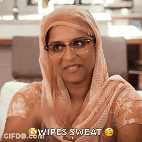 Woman With Glasses And Scarf Wiping Sweat GIF