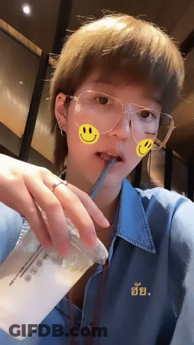 Woman With Glasses And Smiley Face Drinking GIF