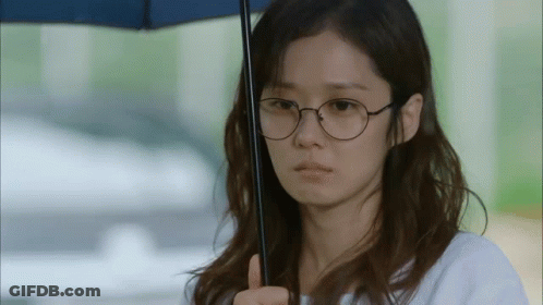 Woman With Glasses And Umbrella Making Funny Face GIF