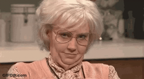 Woman With Glasses And Wig Making Funny Face GIF