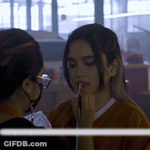Woman With Glasses Applying Makeup To Another Woman GIF