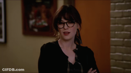 Woman With Glasses Arms Crossed In Front Of Painting GIF