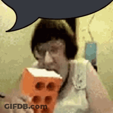 Woman With Glasses Eating Brick GIF