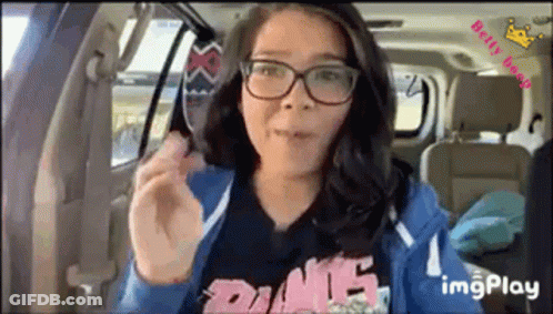Woman With Glasses Eating Food In Back Seat GIF