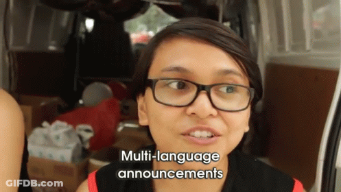 Woman With Glasses Giving Multi-Language Announcements By Van GIF