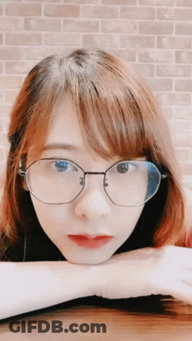 Woman With Glasses Hand On Chin GIF
