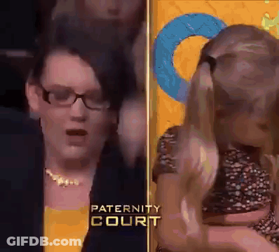 Woman With Glasses Holding Child At Paternity Court GIF