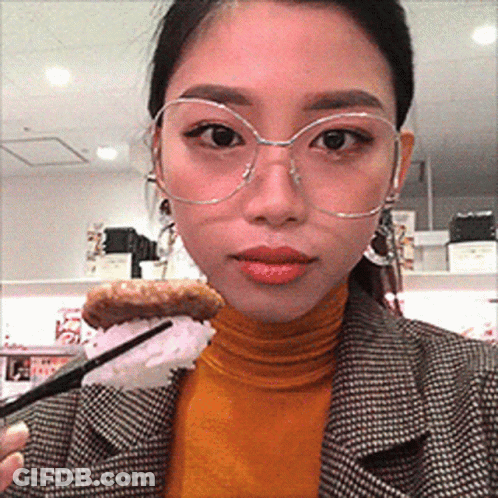 Woman With Glasses Holding Food GIF