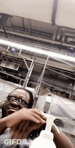Woman With Glasses Holding Soap Bottle GIF