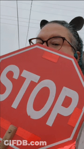 Woman With Glasses Holding Stop Sign GIF