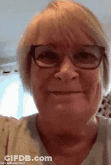 Woman With Glasses In White Shirt Smiling GIF