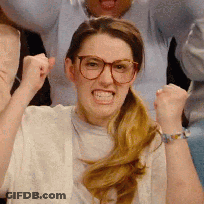 Woman With Glasses Making Funny Face Holding Fist Up GIF