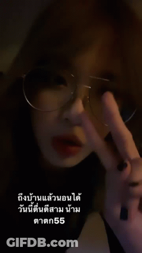 Woman With Glasses Making Peace Sign GIF