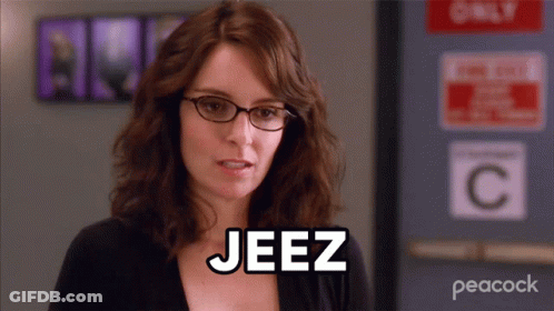 Woman With Glasses Saying Jeez In Front Of Only C Sign GIF